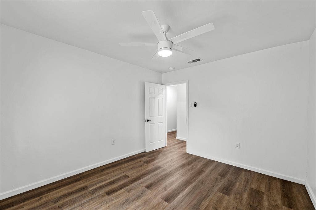1132 Western Oaks Drive, Woodway, TX 76712 Wood-finish flooring, white walls, and a ceiling fan with integrated lighting