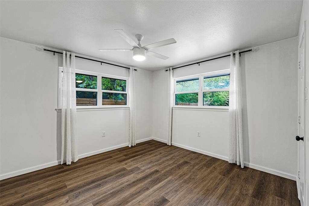 1132 Western Oaks Drive, Woodway, TX 76712 Wood-finish flooring, white walls, and a ceiling fan with integrated lighting