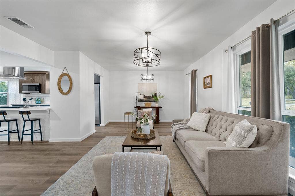 1132 Western Oaks Drive, Woodway, TX 76712 Open concept living area featuring wood-finish flooring, recessed lighting, and a modern chandelier