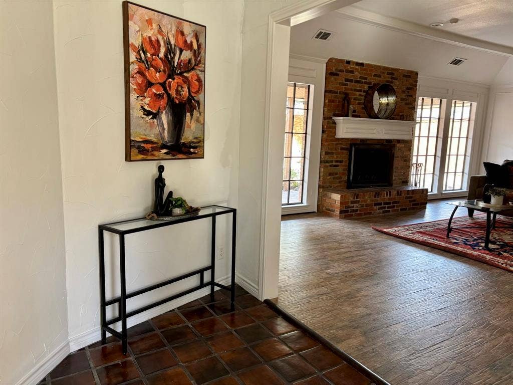 3713 San Juan Circle, Plano, TX 75023 Brick fireplace with a substantial white mantel, multiple large windows, and a vaulted ceiling