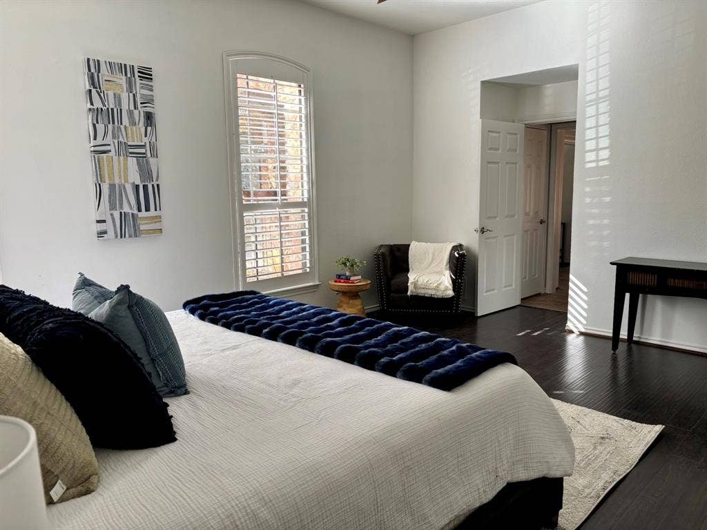 3713 San Juan Circle, Plano, TX 75023 High ceilings, arched window with plantation shutters, dark wood-finish flooring, and a white paneled door