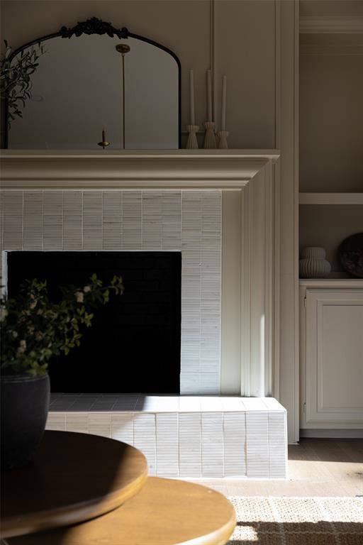 5901 Glen Heather Drive, Plano, TX 75093 Architectural fireplace detail showcases the layered millwork, textured tile surround, raised hearth, and adjacent built-in cabinetry that give the room a custom finish