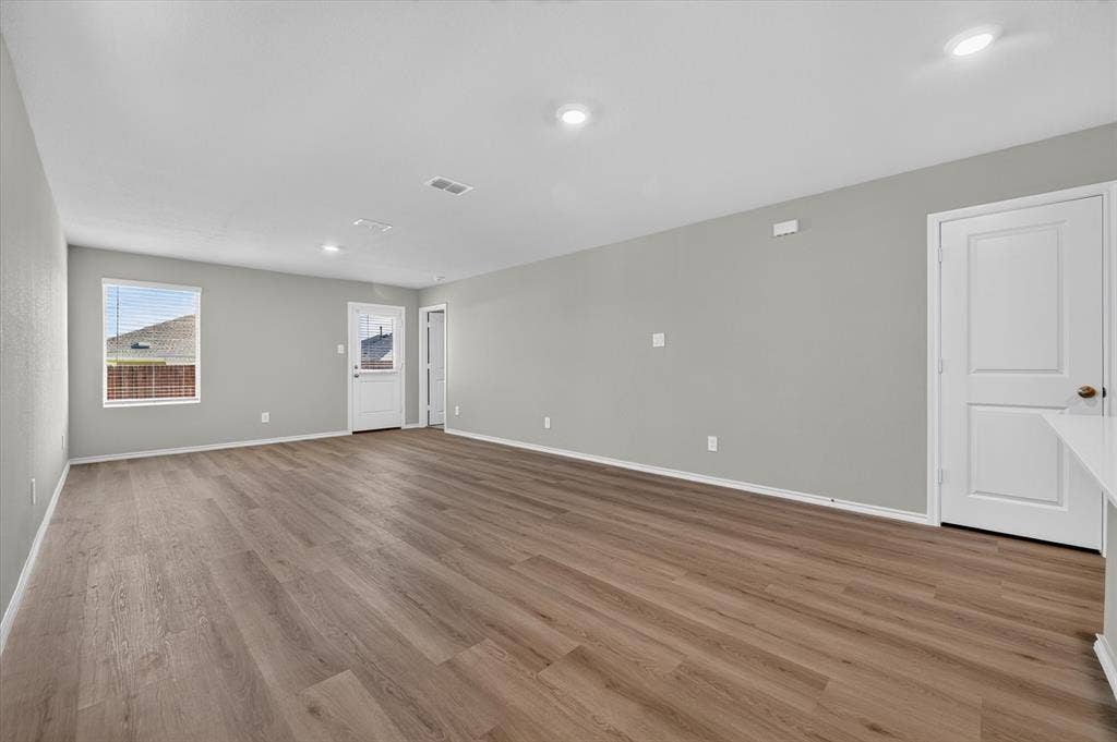 5413 Flannel Lane, Denton, TX 76249 Spacious room featuring wood-finish flooring, recessed ceiling lighting, and light grey walls