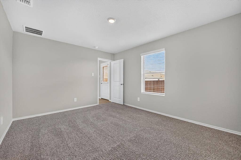 5413 Flannel Lane, Denton, TX 76249 Neutral gray walls with white trim, gray carpet flooring, white window blinds, and a recessed ceiling light