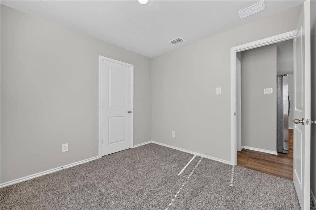 5413 Flannel Lane, Denton, TX 76249 Neutral tone wall paint, textured carpeting, white trim, and two-panel interior doors