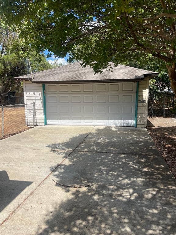 1527 Harbor Road, #1527, Dallas, TX 75216 Detached garage with a paneled door, pitched roof, and concrete driveway