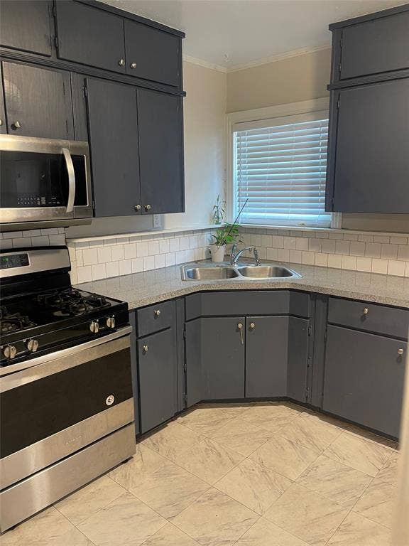 1527 Harbor Road, #1527, Dallas, TX 75216 Stainless steel range with matching microwave, gray cabinetry, textured countertops, subway tile backsplash, and light-toned tile flooring
