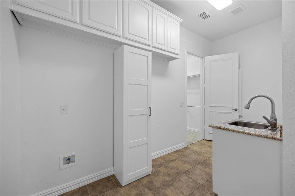 5960 Indigo Sky Drive, Frisco, TX 75036 One of the primary closets leads to the laundry room for convenience!