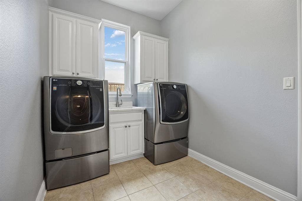 1011 Three Rivers Drive, Prosper, TX 75078 Spacious utility room with sink, upper cabinetry, and flexible gas or electric dryer connections foradded convenience.