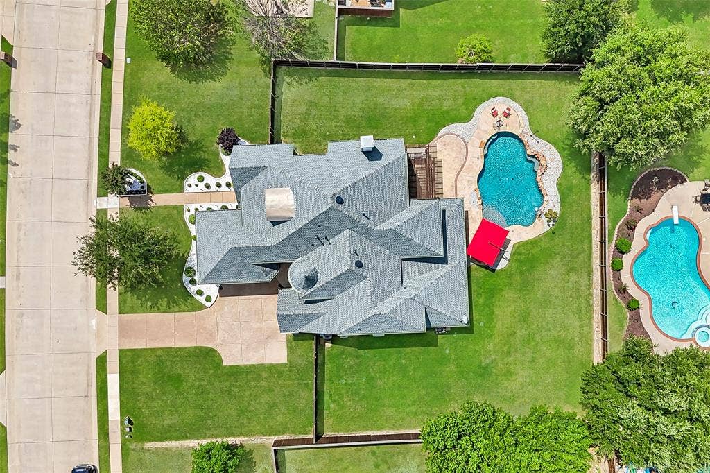 1011 Three Rivers Drive, Prosper, TX 75078 Aerial view showcasing the expansive lot andresort-style backyard, nestled within the sought-after Lakes of La Cima neighborhood, complete with a sparkling pool and generous outdoor livingspace.