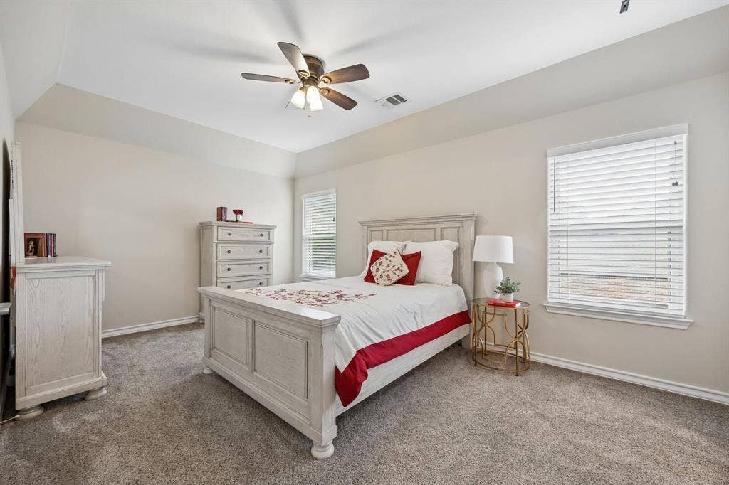 1011 Three Rivers Drive, Prosper, TX 75078 Spacious secondary bedroom with vaulted ceilings,soft natural light, and generous space for guests or everyday living.