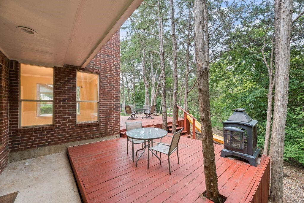 7030 Pecan Creek Circle, Midlothian, TX 76065 Multi-level wood deck with integrated trees and a brick exterior