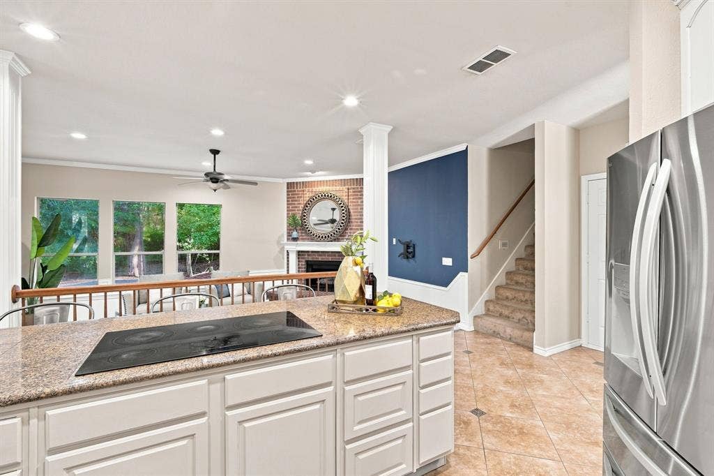 7030 Pecan Creek Circle, Midlothian, TX 76065 A closer look at the kitchen island, finished with a handsome stone-look countertop and built-in electric cooktop, perfect for entertaining.