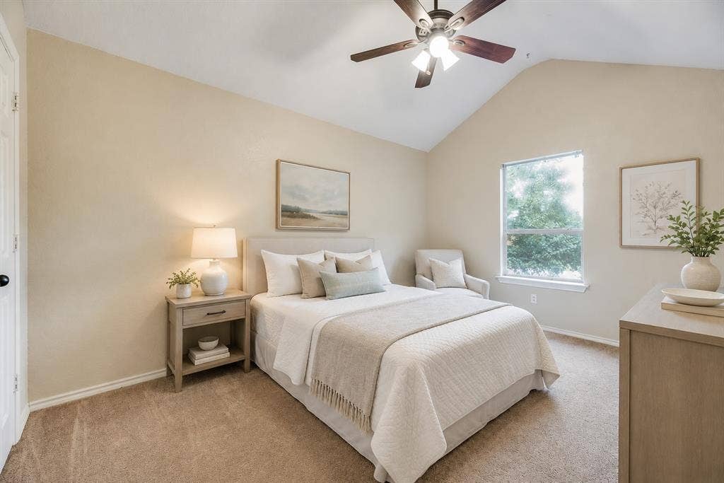 7030 Pecan Creek Circle, Midlothian, TX 76065 Spacious bedroom with vaulted ceilings, abundant natural light, and a comfortable layout offering plenty of room to relax and unwind.