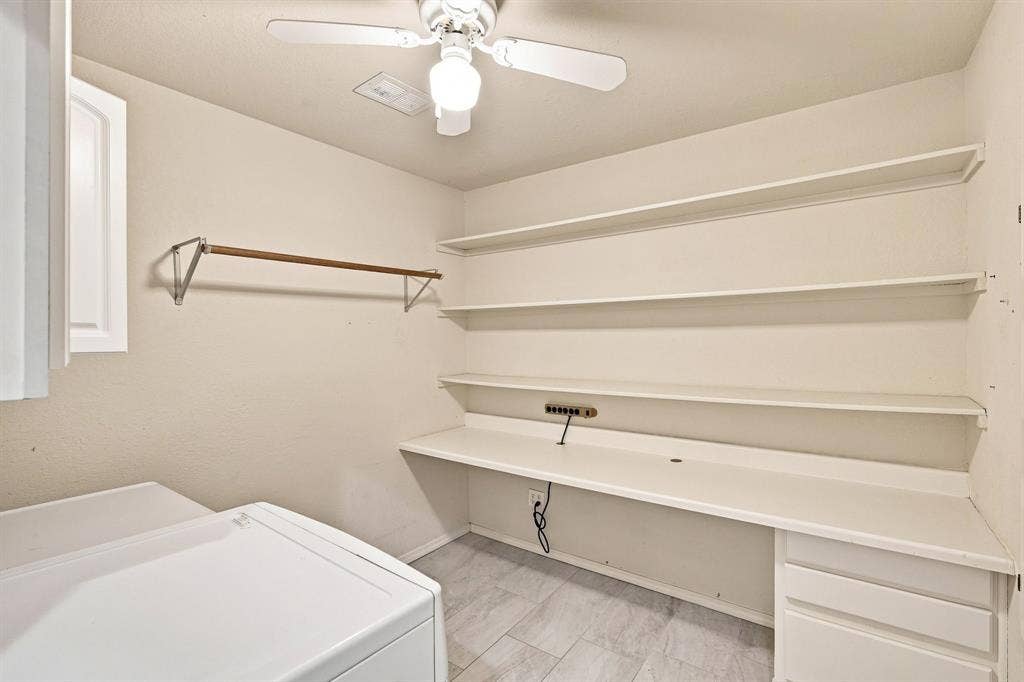 7030 Pecan Creek Circle, Midlothian, TX 76065 Functional laundry and utility space with recessed lighting, built-in cabinetry, and a hand folding station.
