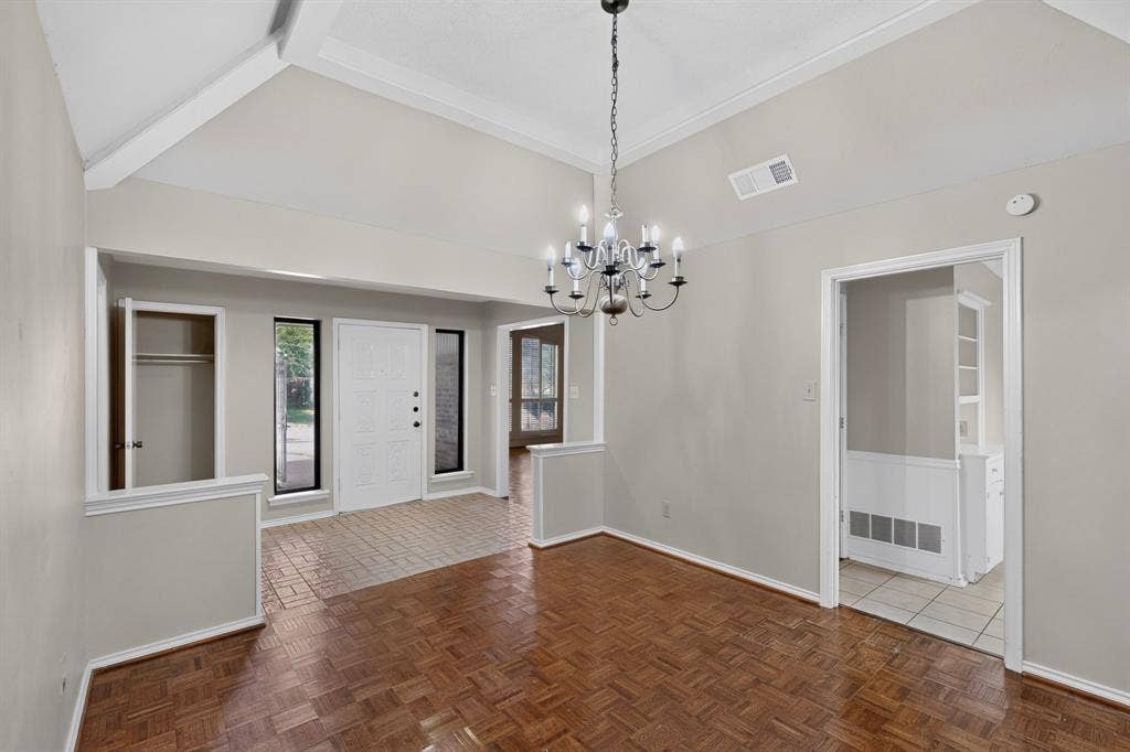 1606 Treehouse Lane, Plano, TX 75023 Vaulted ceiling with exposed beams, wood-finish flooring, white paneled entry door, recessed entry, and an elegant chandelier