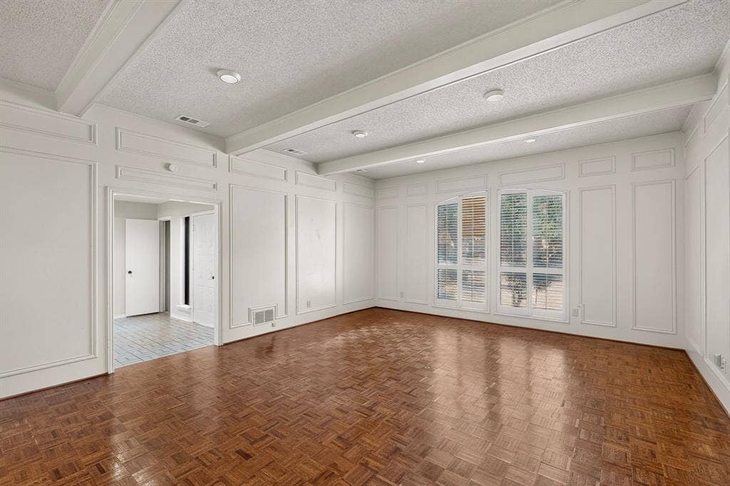 1606 Treehouse Lane, Plano, TX 75023 Wall paneling with decorative trim, wood-finish flooring, coffered ceiling, recessed lighting, and large windows
