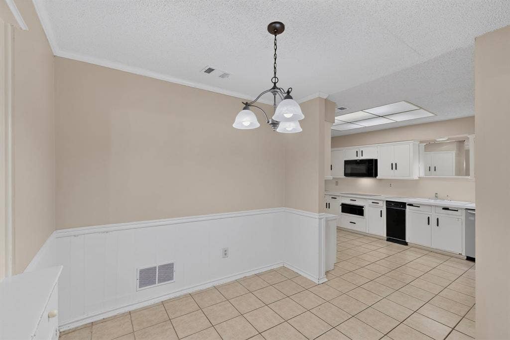 1606 Treehouse Lane, Plano, TX 75023 Kitchen featuring white cabinetry, built-in microwave, and tile flooring