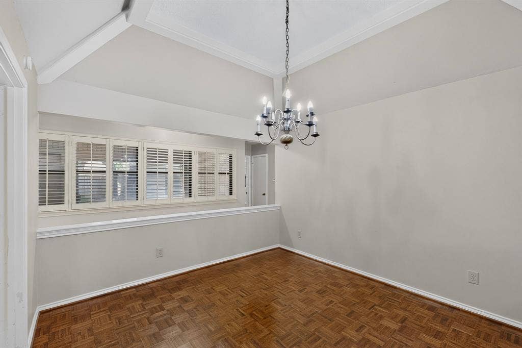 1606 Treehouse Lane, Plano, TX 75023 Vaulted ceiling with exposed beam, chandelier lighting, parquet wood-finish flooring, and upper-level windows with plantation shutters