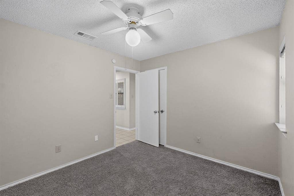 1606 Treehouse Lane, Plano, TX 75023 Wall-to-wall carpeting, ceiling fan, and window