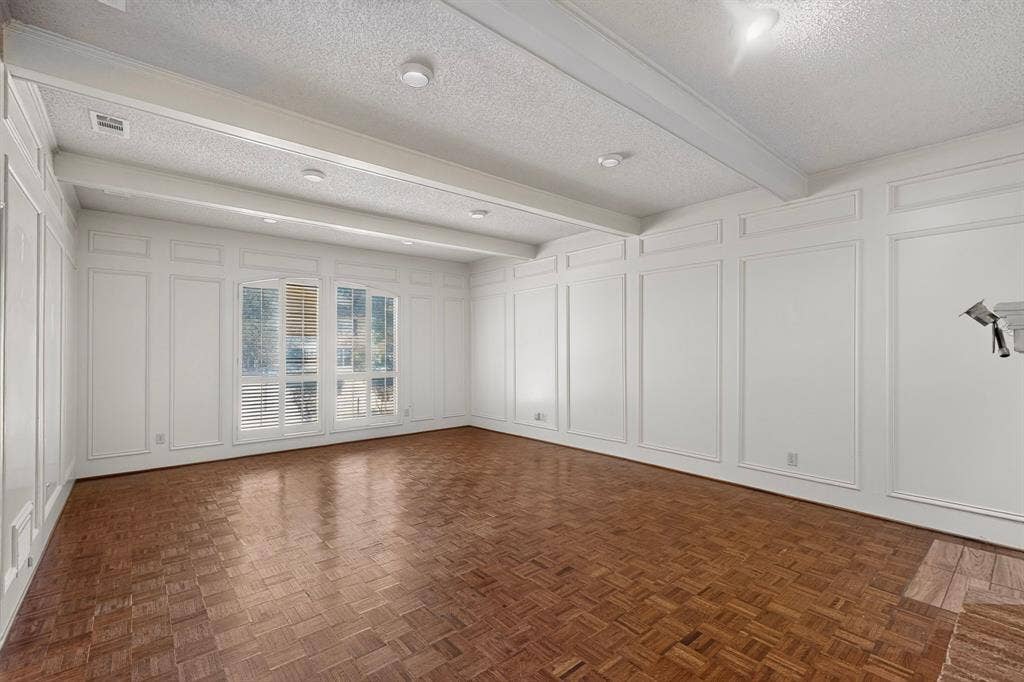 1606 Treehouse Lane, Plano, TX 75023 Parquet wood-finish flooring, recessed lighting, decorative wall paneling, and a beamed ceiling