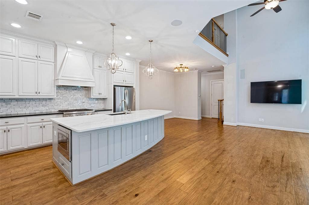 Open-concept kitchen flows seamlessly into the surrounding living & entertaining spaces, creating an easy everyday gathering place.