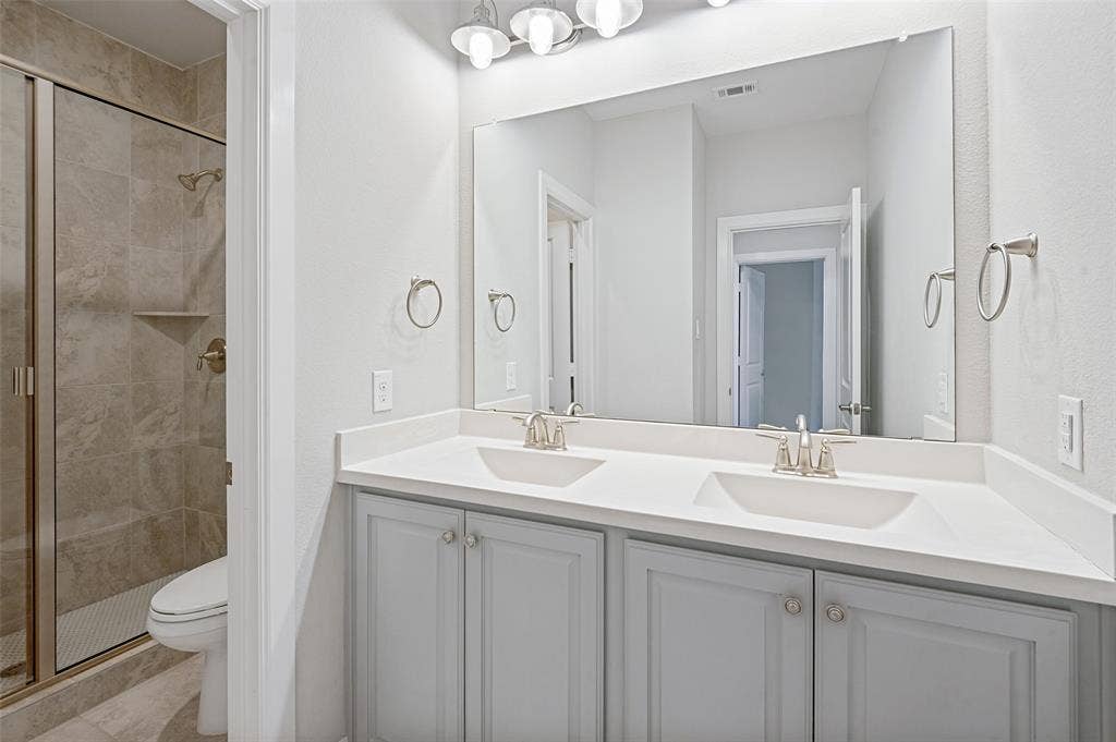 A bright, welcoming secondary bath gives family & guests a comfortable space of their own, with a generous vanity, ample storage & timeless finishes.