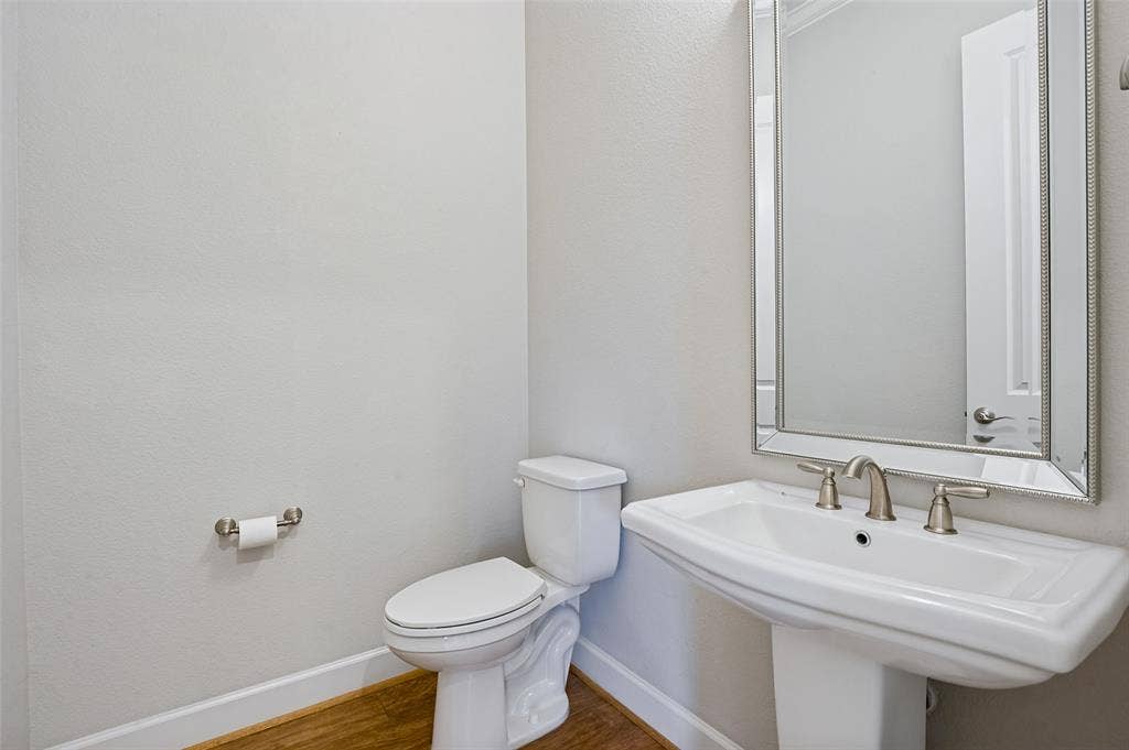 Convenient main-level powder bath with pedestal sink is perfectly positioned for guests.
