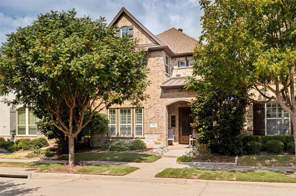 Beautiful stone & brick exterior framed by mature trees, fresh sod & inviting curb appeal in sought-after Spicewood at Craig Ranch.
