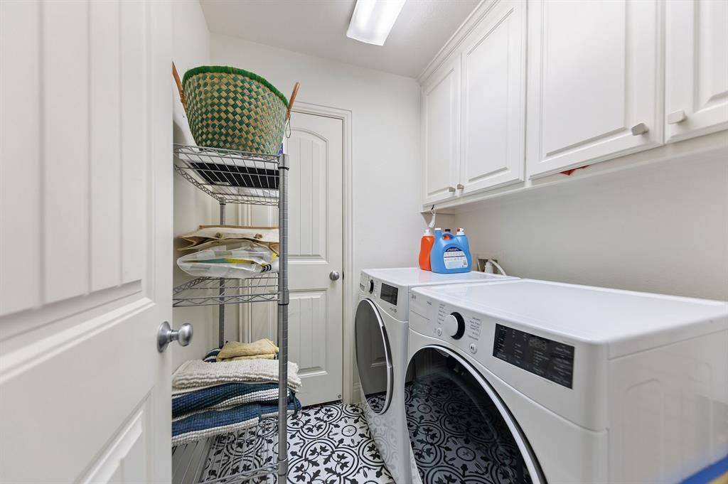 7011 Nueces Drive, Irving, TX 75039 White shaker-style cabinetry, patterned tile flooring, and a flush-mount overhead light fixture