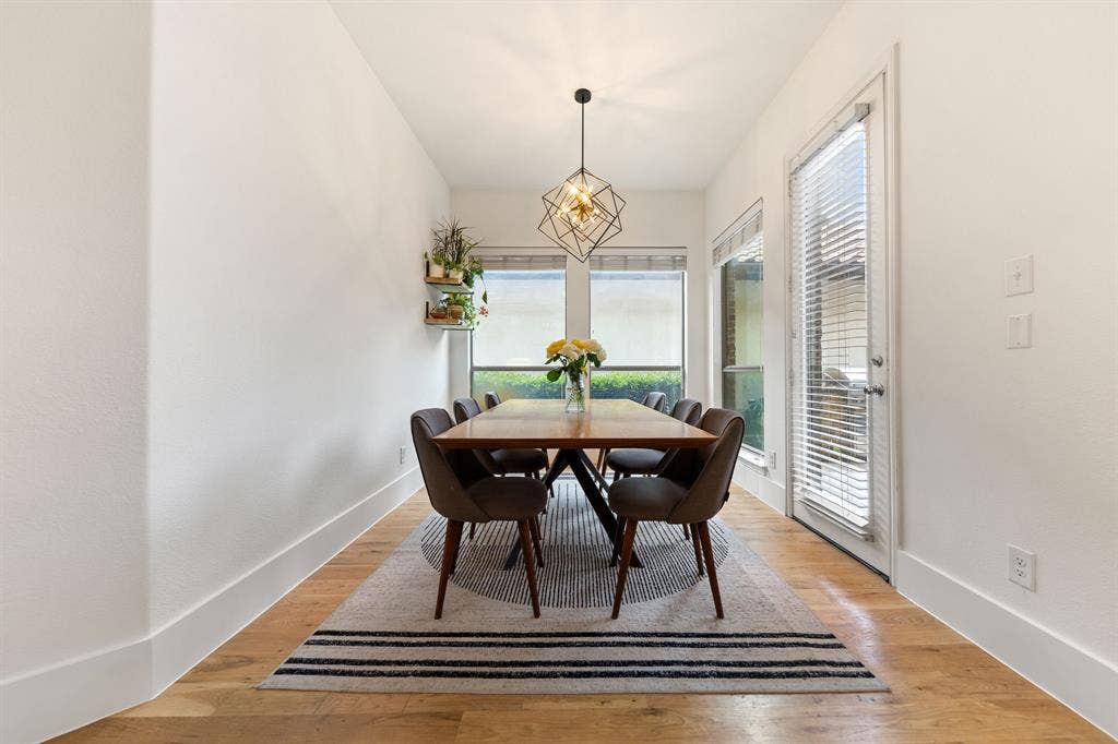 7011 Nueces Drive, Irving, TX 75039 Wood-finish flooring, white walls, and a geometric pendant light fixture