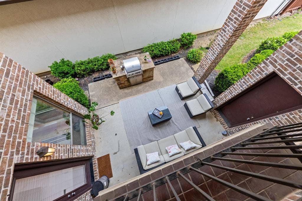 7011 Nueces Drive, Irving, TX 75039 Outdoor patio with concrete and tile flooring, brick walls, and an integrated grilling station