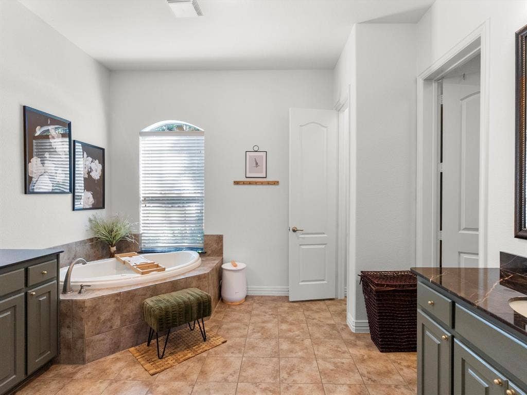 Ensuite primary bathroom with dual vanities and private toilet closet
