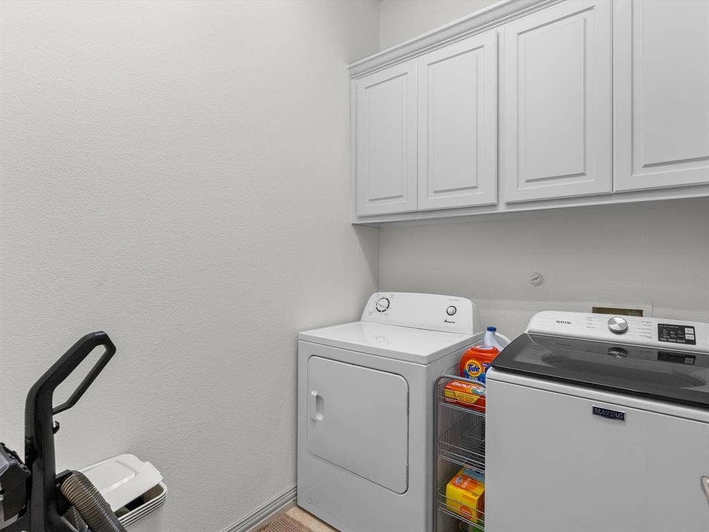 First-level laundry room with storage cabinets
