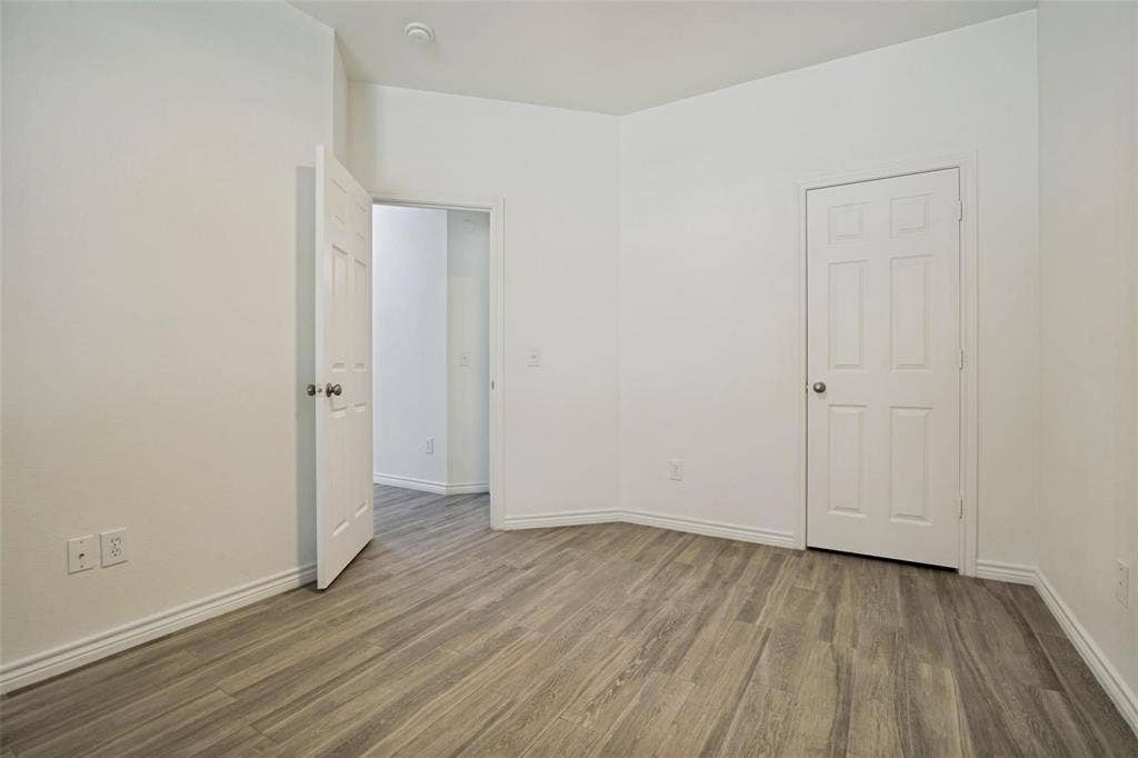 1516 Cedar Grove Court, Allen, TX 75002 Wood-finish flooring, white paneled doors, and white walls