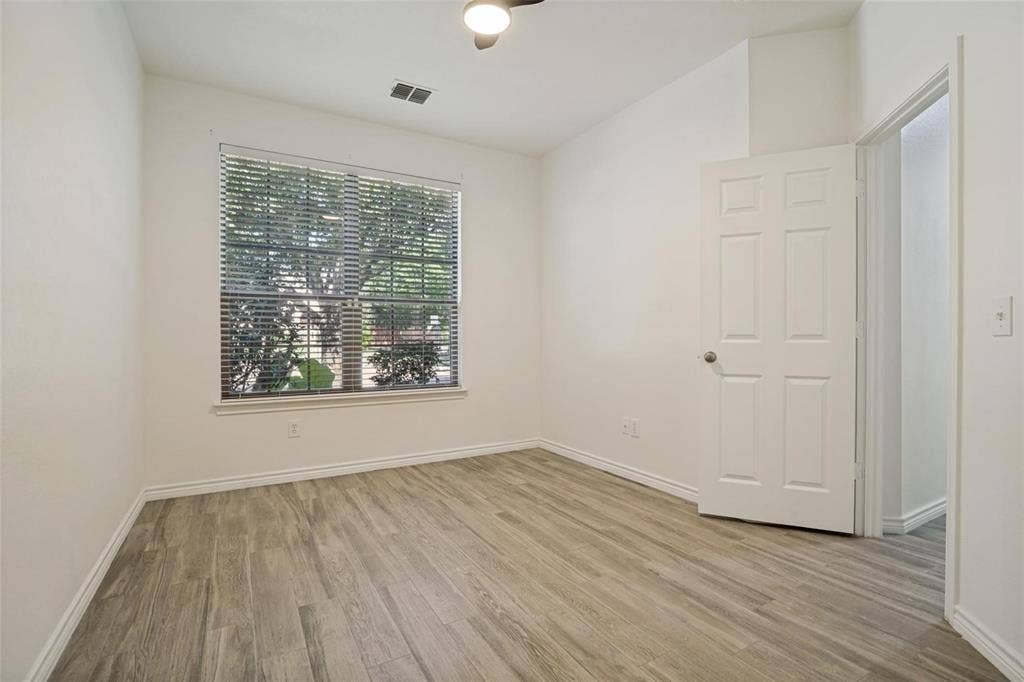 1516 Cedar Grove Court, Allen, TX 75002 Wood-finish flooring, white paneled door, and a window with blinds