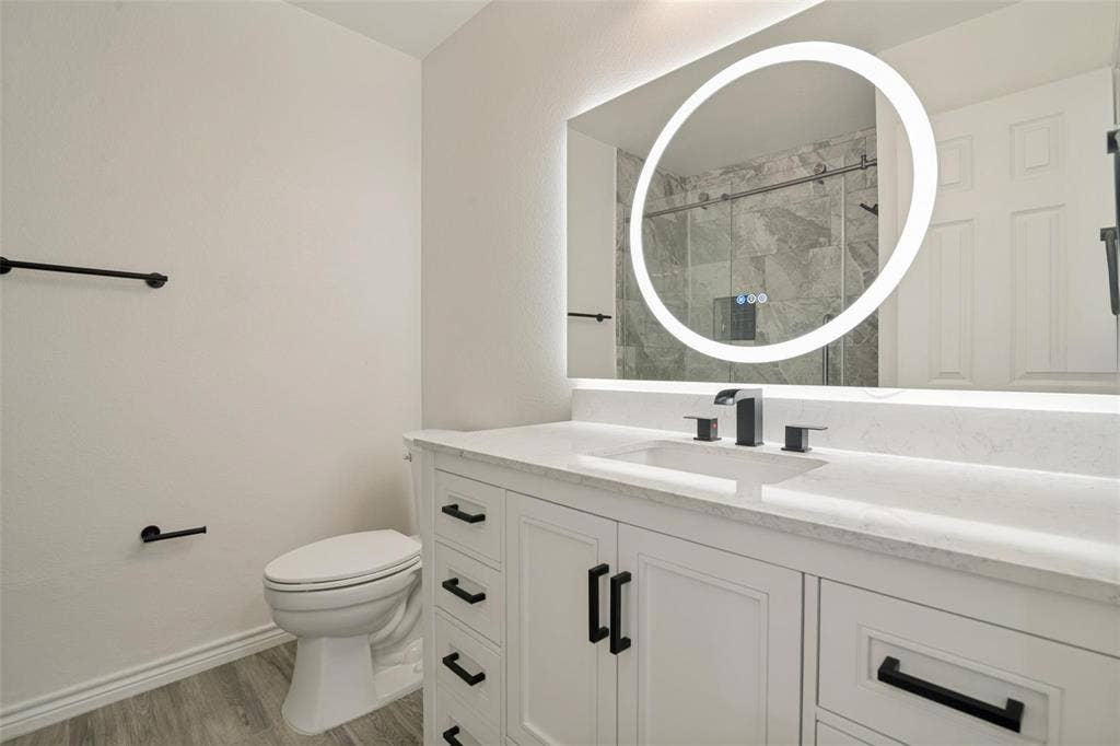1516 Cedar Grove Court, Allen, TX 75002 White vanity cabinetry with matte black hardware, integrated sink, and quartz countertop