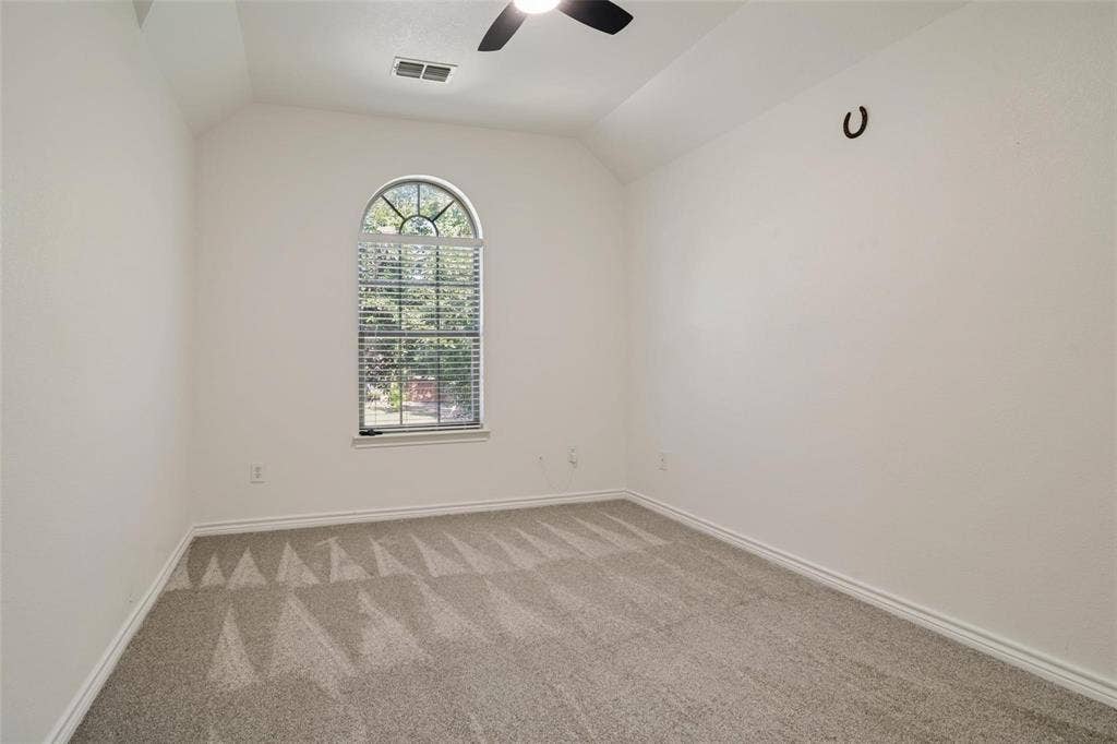 1516 Cedar Grove Court, Allen, TX 75002 Arched window with blinds, vaulted ceiling, and ceiling fan