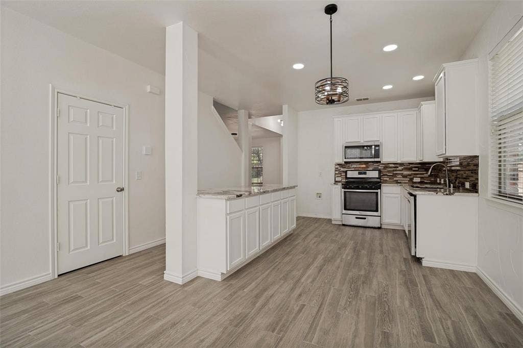 1516 Cedar Grove Court, Allen, TX 75002 Contemporary kitchen featuring stainless steel appliances, white cabinetry, and a mosaic tile backsplash