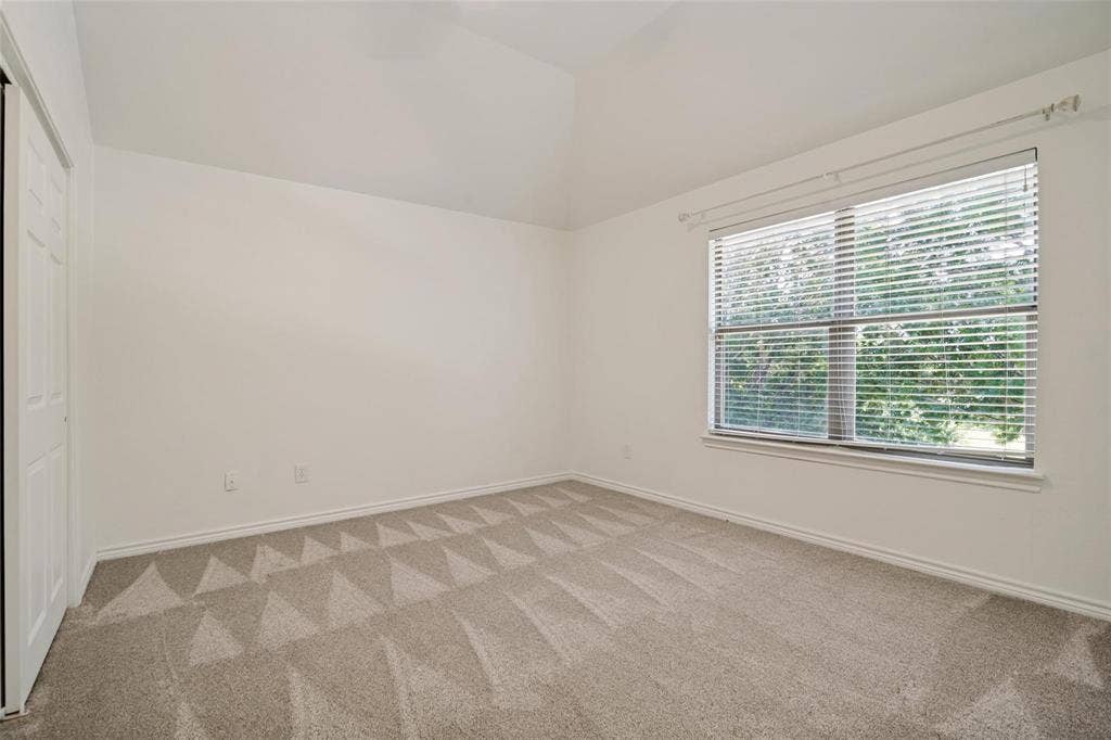 1516 Cedar Grove Court, Allen, TX 75002 Vaulted ceiling, neutral wall paint, carpeted flooring with geometric pattern, window with blinds, bi-fold closet door