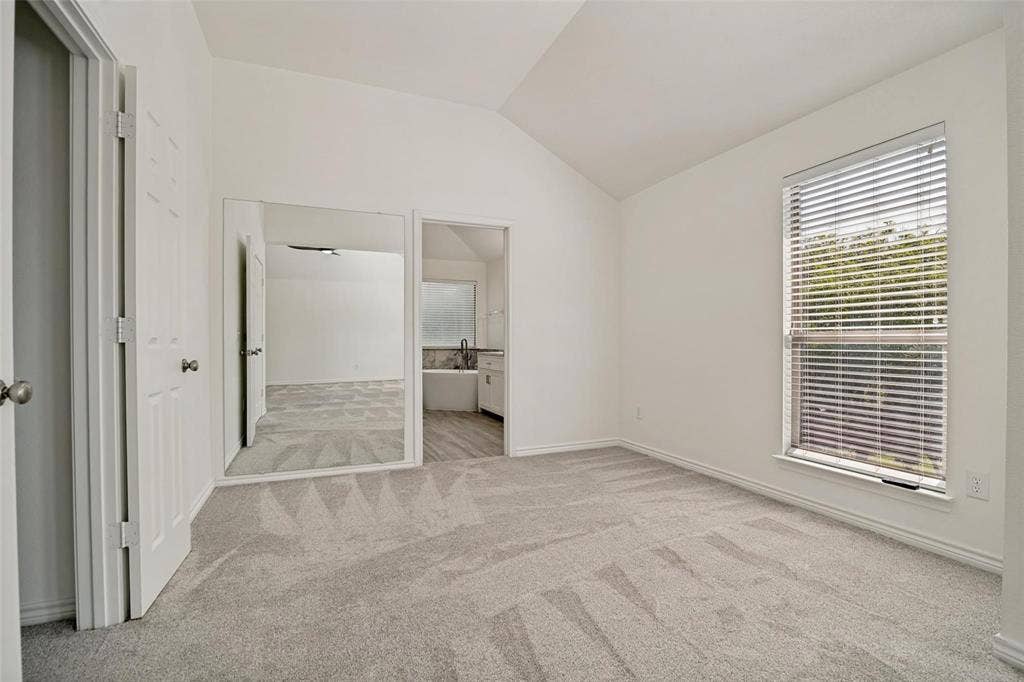 1516 Cedar Grove Court, Allen, TX 75002 Vaulted ceiling, neutral tone carpeting, window with blinds, interior door, and mirrored closet doors