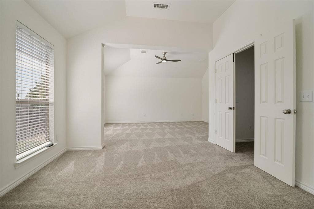 1516 Cedar Grove Court, Allen, TX 75002 Spacious interior featuring a large window with blinds, light-toned patterned carpeting, and white paneled doors