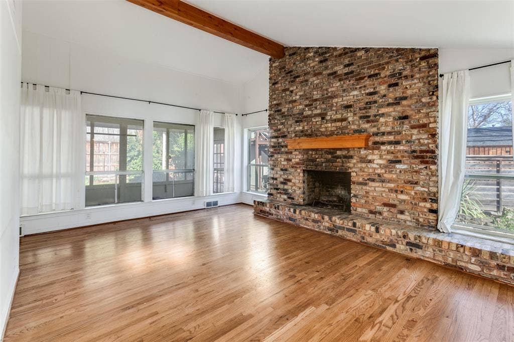 9759 Shoreview Road, Dallas, TX 75238 Gas FP; view through windows to sunroom. Beautiful hardwoods.