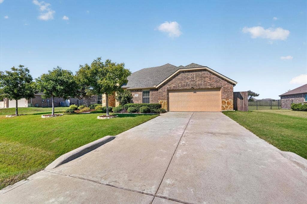 Brick and stone exterior with a two-car garage
