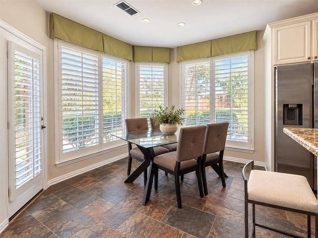 2912 Meadow Glen Drive, Flower Mound, TX 75022 Bay window with plantation shutters, tile flooring, recessed lighting, and a stainless steel refrigerator