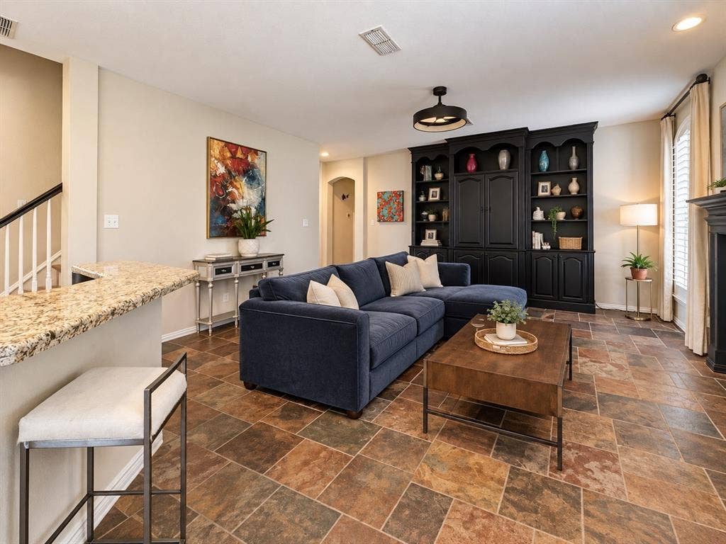 2912 Meadow Glen Drive, Flower Mound, TX 75022 Built-in shelving unit, multi-tone tile flooring, breakfast bar with stone countertop, staircase with white spindles, and window with plantation shutters