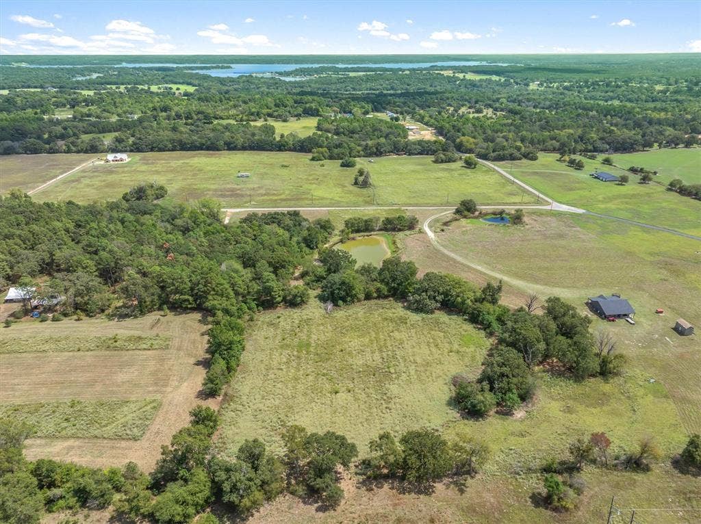 24619 Private Road 8102, Frankston, TX 75763 Expansive rural landscape featuring multiple parcels, mature tree lines, and a distant body of water