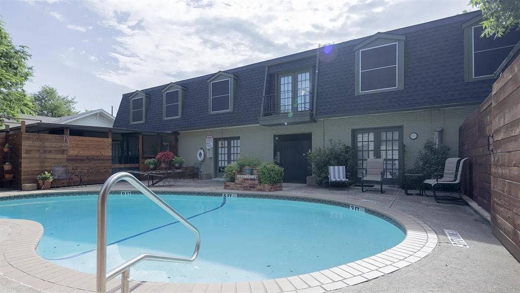 1717 N Locust Street, #6, Denton, TX 76201 Outdoor swimming pool with integrated steps, surrounded by concrete decking and brick coping
