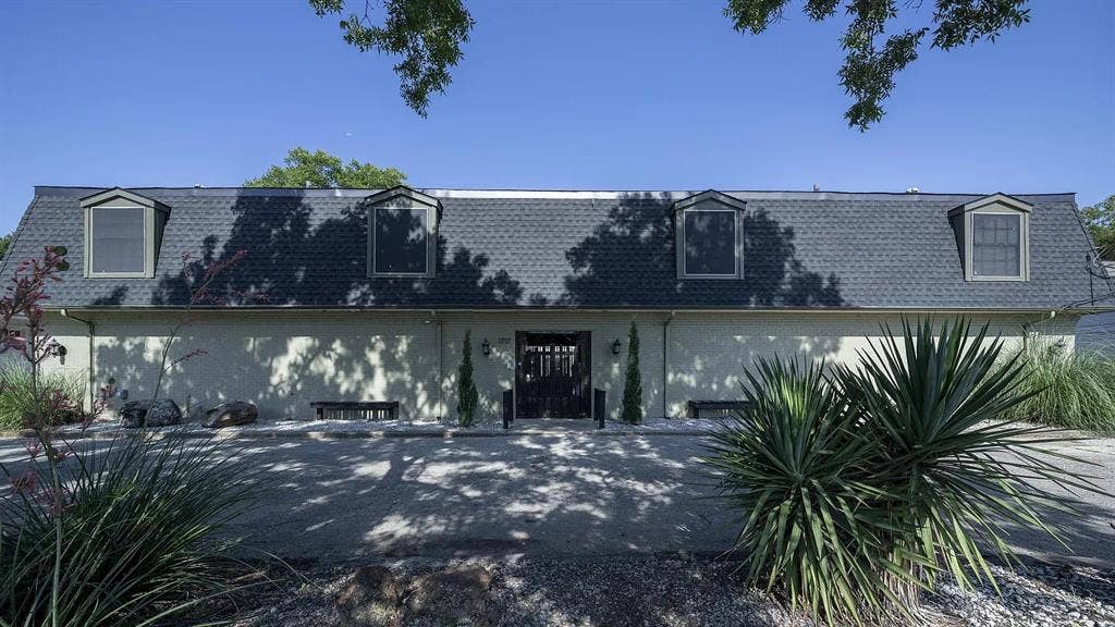1717 N Locust Street, #6, Denton, TX 76201 Gable dormer windows, a dark shingled gambrel roof, and light-colored stucco exterior