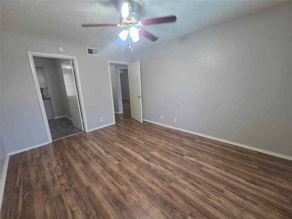 1717 N Locust Street, #6, Denton, TX 76201 Wood-finish flooring, light gray wall finishes, and a ceiling fan with integrated lighting